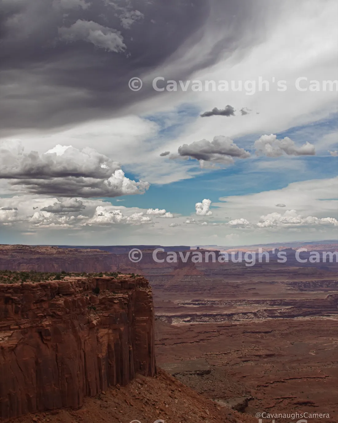 Dramatic storm clouds over a red rock canyon overlook in Canyonlands National Park